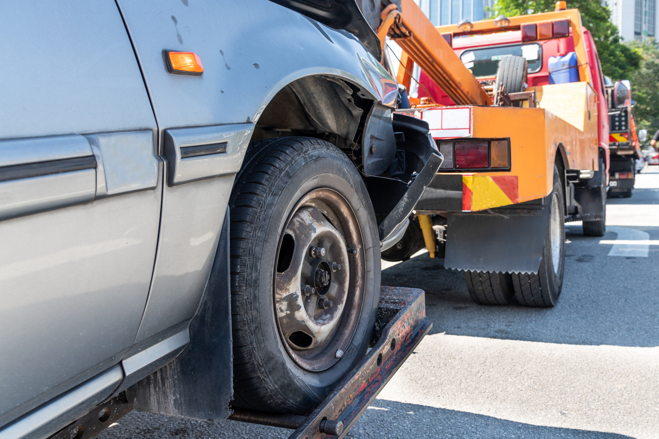 Tow truck towing a broken down car in emergency