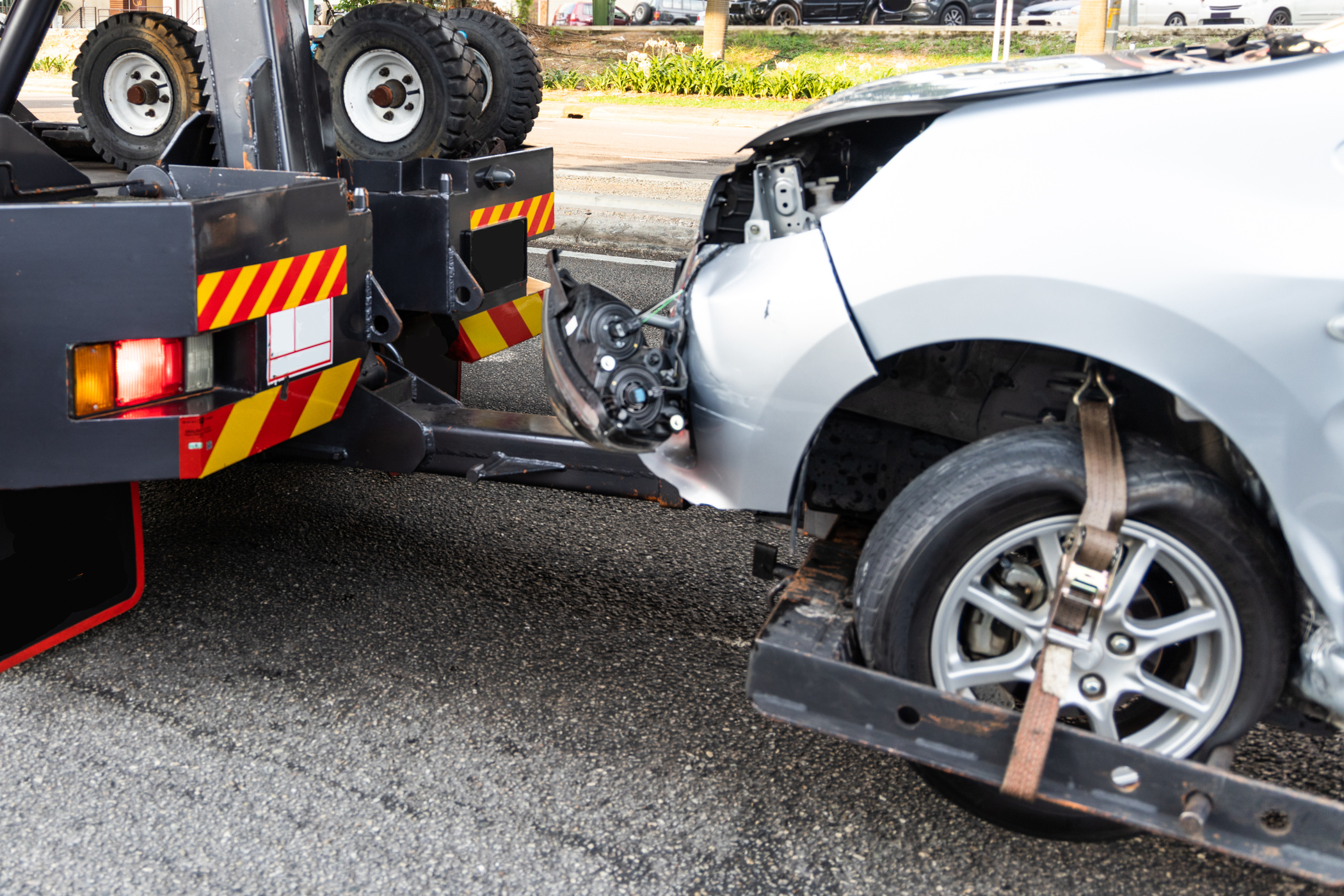 Tow truck towing broken down car from accident